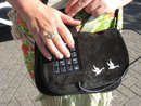 woman's hand on a keyboard embedded into a suade bag